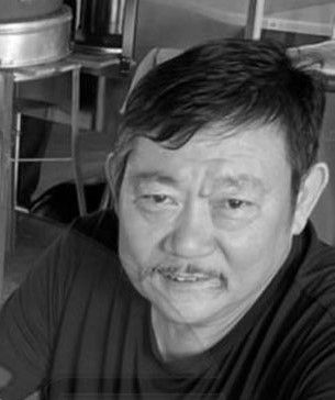 Lu Di Geng, a middle-aged man with short black hair and a mustache.