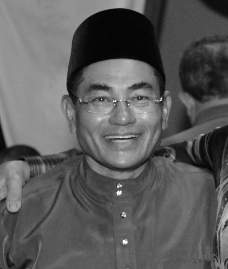 Ismail poses with a smile while donning traditional Malay attire