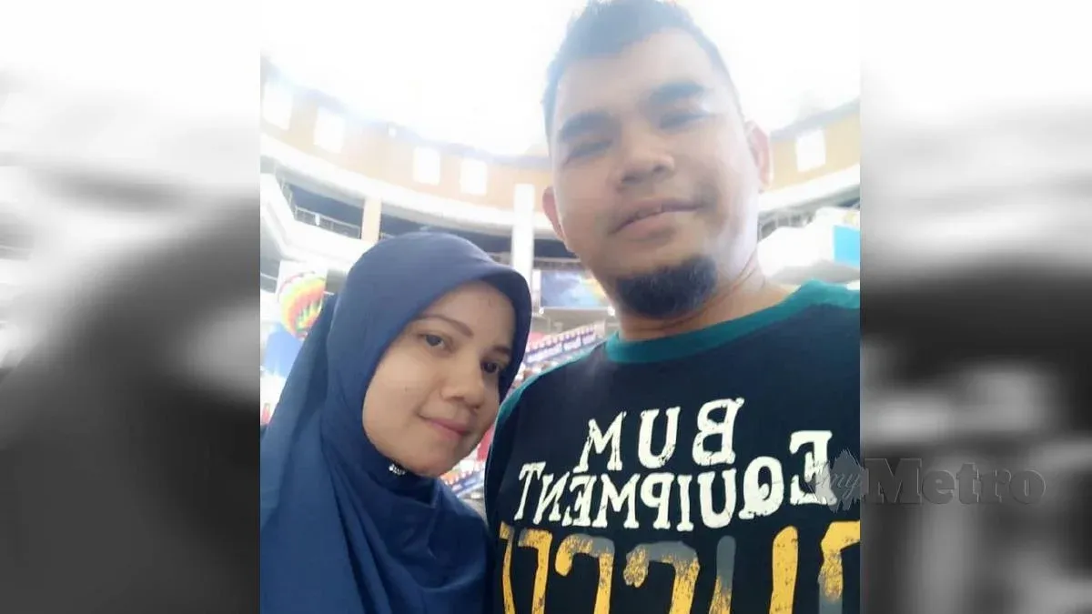 Hamzah Md Yusof smiles in a selfie with his wife. He has a goatee and bushy eyebrows.